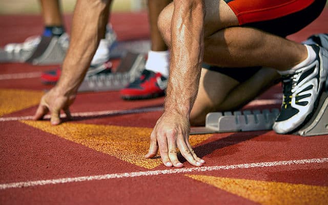 Man at track starting block
